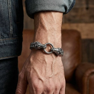 Close-up of vintage steel men's bracelet with twin beast heads and woven chain