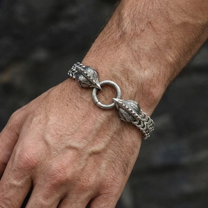Detailed view of vintage silver eagle heads and woven chain on a men's steel bracelet