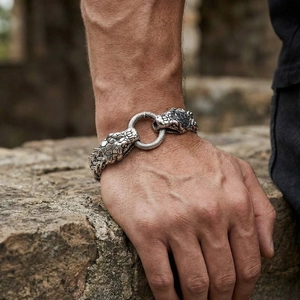 Detailed view of men's vintage steel bracelet with snake head clasp on wrist