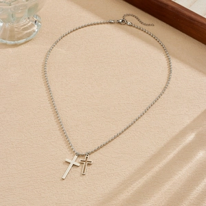 Detailed view of stainless steel bead chain necklace with solid and hollow cross pendants