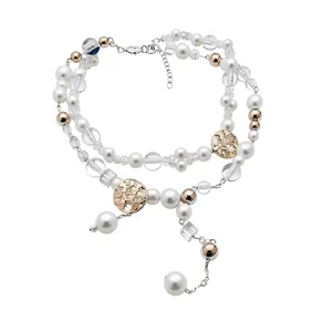 Elegant double-layer pearl necklace with golden floral pendants and clear beads