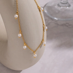 Minimalist 18K gold plated titanium necklace featuring delicate round white pearls
