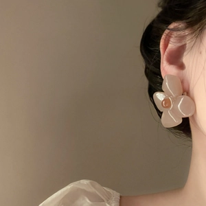 Close-up of a French retro acrylic flower earring in pale tea pink jelly finish