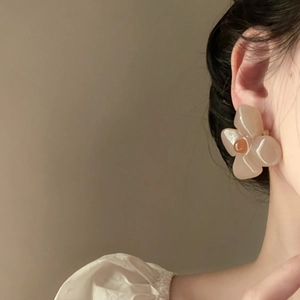 Close-up detail of French retro Thai tea jelly color acrylic flower earring on model ear