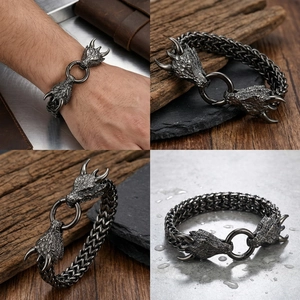 Macro detail of men's steel dragon head bracelet with vintage finish and woven chain
