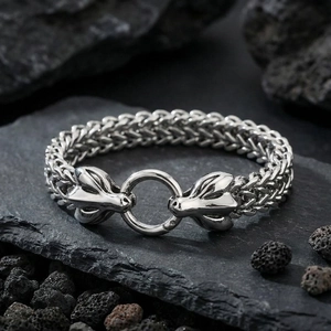 Detailed view of silver dragon head connectors on a thick wheat chain biker bracelet