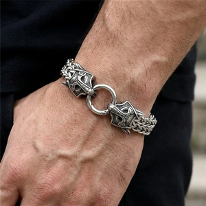 Detail of vintage wolf head stainless steel bracelet with braided chain for men