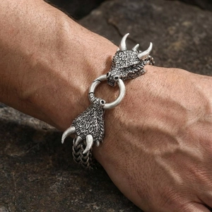 Detailed macro view of vintage dragon head men's steel bracelet with engraved link chain