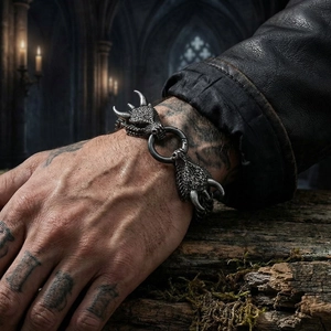 Close-up of vintage dragon head clasp on steel biker bracelet with gothic lighting