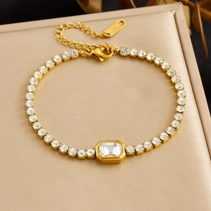 Elegant detail of a gold-plated stainless steel bracelet featuring square cubic zirconia stones