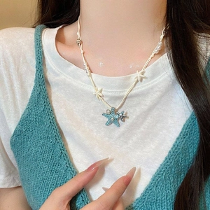 Summer beach style blue starfish pendant necklace with pearls and white star accents