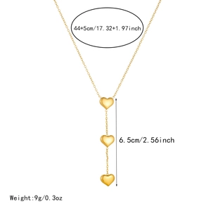 Detail of gold-plated stainless steel layered necklace with triple heart pendants
