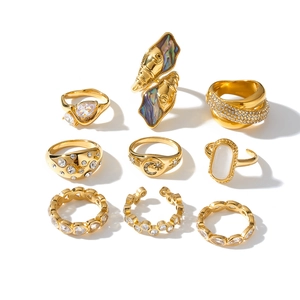 Detailed macro view of 9-piece gold stainless steel ring set featuring various stones