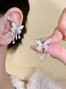 Elegant silver butterfly tassel ear cuffs with sparkling stones displayed on ear detail