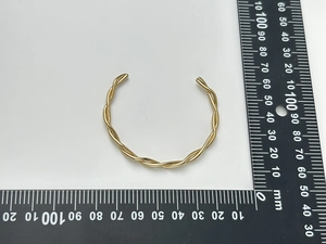 Detailed measurement of a golden twisted rope cuff bracelet showing a 60mm diameter scale