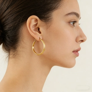 Classic 18K gold-plated stainless steel hoop earrings featuring Greek meander motifs on model