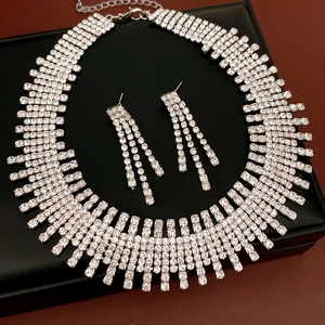 Detailed view of an elegant silver rhinestone tassel necklace and earring jewelry set