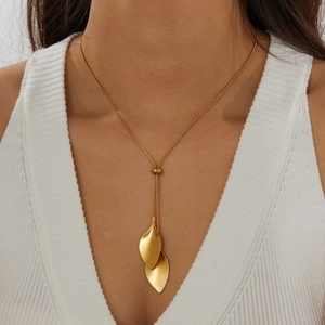 Detailed view of an elegant gold leaf pendant necklace featuring an adjustable snake chain