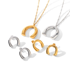 Detail showing minimalist U-shaped pendant necklaces and matching stud earrings