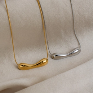 Minimalist 18K gold and silver teardrop pendant necklaces on sleek snake chains