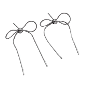 Close-up of gunmetal bow earrings made of snake chain with sleek metallic ends