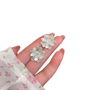 Elegant silver flower stud earrings with sparkling crystals and a niche camellia design