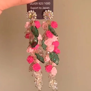 Detail of acrylic floral drop earrings with pink roses and 925 silver needles
