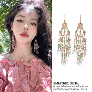 Detailed view of bohemian vintage ethnic style long tassel earrings with colorful beads