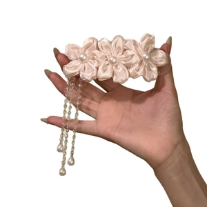 Elegant pink fabric flower hair clip with dangling pearl tassels for a sweet look