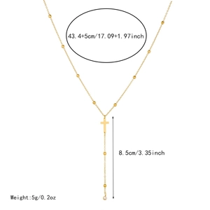Detail of gold double-layered necklace with cross pendant and size measurements