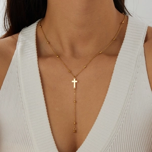 Elegant gold-plated stainless steel Y-shaped necklace featuring a cross pendant on a model