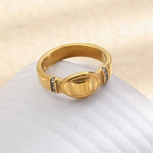 Close-up of a gold-plated stainless steel oval ring with side-set cubic zirconia