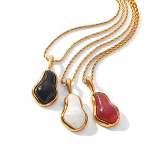 Close-up of three 18K gold plated stainless steel necklaces with colorful teardrop pendants