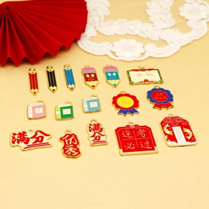 Detailed view of graduation-themed alloy charms including pencils and certificates.
