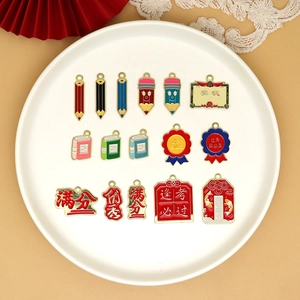 Detailed view of colorful alloy graduation and exam success charms for DIY jewelry making