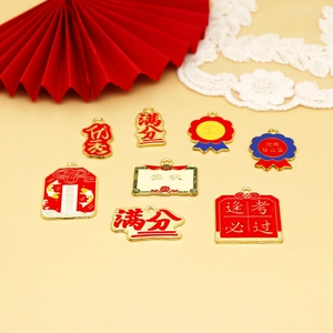 Detailed view of alloy enamel charms with success text for graduation and exams