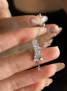 Close-up of geometric zircon ear cuff with sparkling star charms in silver