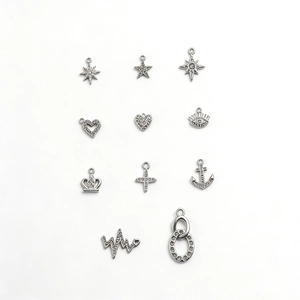 Collection of silver zirconia charms in star, heart, and evil eye shapes for DIY necklaces