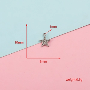 Macro detail of star shaped stainless steel pendant showing dimensions 10mm by 8mm