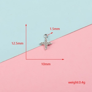 Detail of stainless steel cross star pendant with size and weight markings.