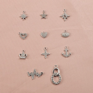 Detailed view of silver stainless steel charms with zircon inlay for jewelry making accessories.