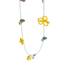 Handmade beaded necklace featuring lemon and flower charms in summer dopamine style.