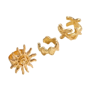 Detailed view of bohemian gold starfish and sun ear cuff set with textured metal finish