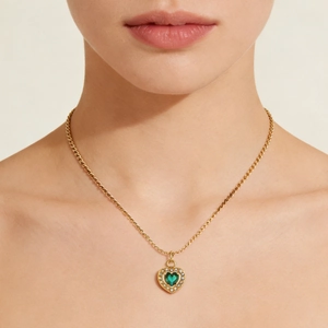 Gold-plated heart pendant necklace with green zircon and white crystals on female neck
