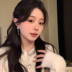 Elegant heart bowknot tassel earrings with zirconia crystals, beautifully shown on a model