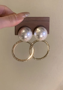 Elegantes pendientes de aro dorados con perlas grandes y detalles de cristal.