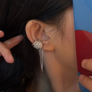 Detailed close-up view of a minimalist silver wide fringe ear cuff worn on the earlobe