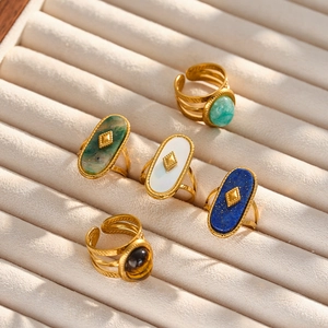 Set of 5 vintage gold stainless steel rings with colorful natural stones on velvet tray