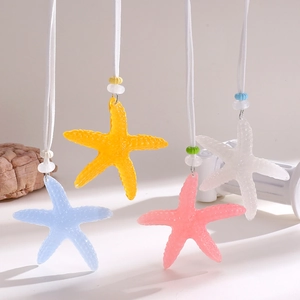 Close-up of colorful textured starfish pendants in blue, yellow, pink, and white colors.