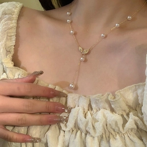 Elegant 18k gold plated leaf necklace with pearls and zircons worn on model neck